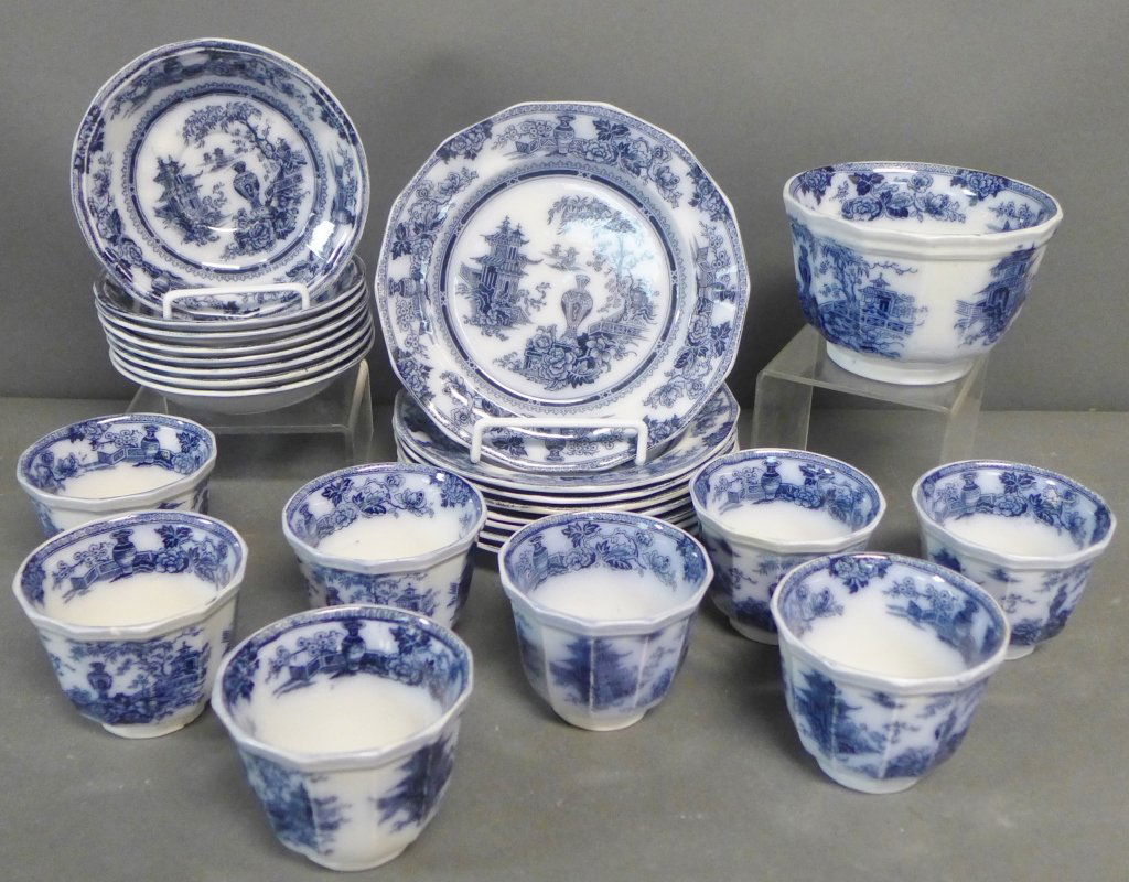 W Adams & Sons Ironstone Grouping: Collection of blue and white JEDDO pattern fine china. Maker's mark on bottom. Assortment includes: -1 bowl. Height: 3 1/2" -8 cups and saucers -8 plates. Diameter: 7 1/2" (Flow Blue Earthenware, porc