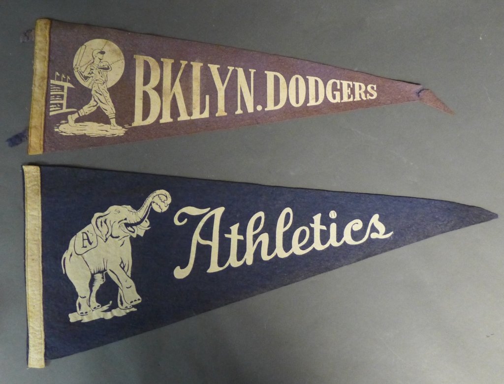 Two Rare Baseball Pennant Flags: Two Vintage felt baseball pennants. -Brooklyn Dodgers Pennant 1940's / 1950's with abbreviated name. -Philadelphia Athletics 1940's / 1950's Pennant with elephant. Height: 11 1/2", Length: 28 1/2" Som
