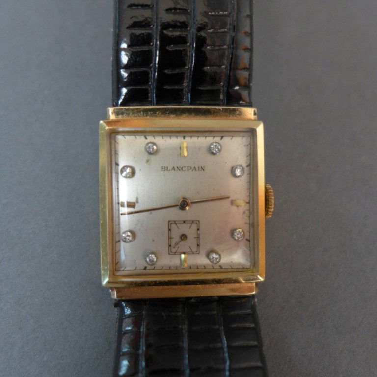 Gentleman's Blancpain Gold & Diamond Wrist Watch: Vintage Blancpain 14k yellow gold square wristwatch features 8 diamonds and a black band. 398523 / 17 Jewels Inscribed on back. Height: 9 1/2"; Width: 1"; Depth: 3/8". Total approximate weight: 21 gra