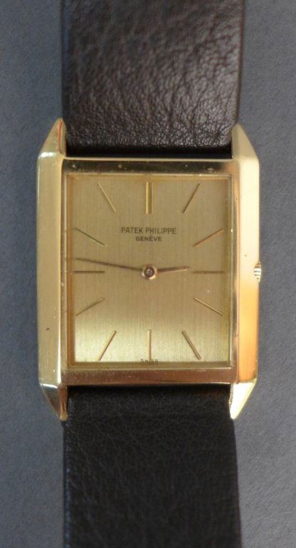 Gentleman's 18k Patek Philippe Wrist Watch: Square 18k yellow gold men's Patek Philippe wrist watch. Swiss made. On brown leather band. 255073 / 3491 / 18 Jewels / Five pos. / 1136331. Height: 9"; Width: 1 1/16"; Depth: 1/4". Total approximate