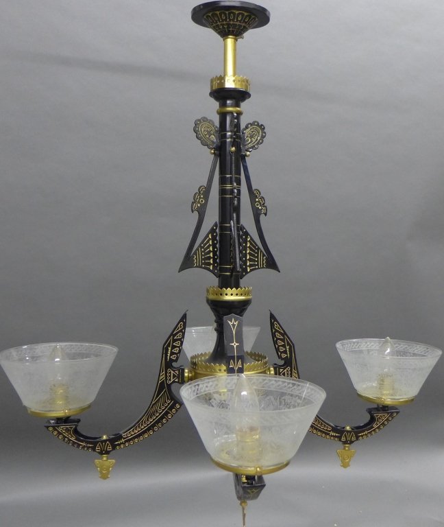 Egyptian Revival Style Chandelier: Egyptian Revival style black and gold tone metal 4 arm chandelier with etched glass shades. Some chips to the bottom of the glass shades. Height: 31", Width: 31" (lighting, electric, interior design, 