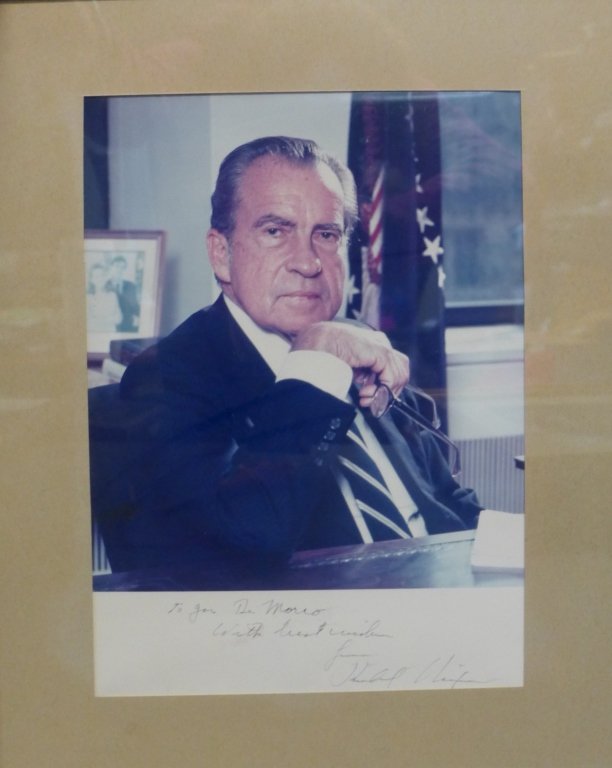 Autographed Photo of Richard Nixon: Color photograph of President Richard Nixon. Inscribed and signed at bottom. Adhered to back is a letter from John H. Taylor (assistant to Nixon) dated 1986. Framed and matted. Height: 14"; Width: 11