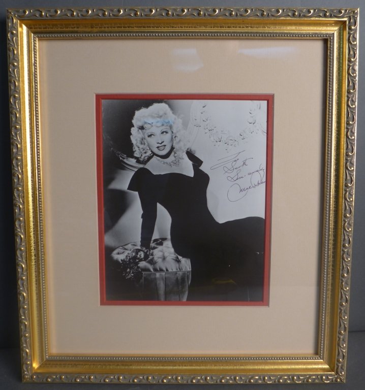 Mae West Autographed Photo: Black and white photograph of Mae West. Inscribed and signed on right side. Framed & matted. No COA. Height: 16 1/2"; Width: 14 3/4". Image Size Height: 9"; Width: 7 1/4". Mary Jane "Mae" West (August