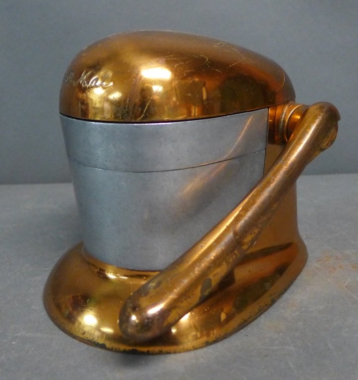 Vintage Juice-O-Matic Juicer: Retro revival 1950's era Juice-O-Mat tilt top citrus juice press. With copper tone finish. Makers mark on bottom. 3 pieces. Height: 6 1/2", Width: 6", Depth: 8". Some age and appropriate wear. (drink,