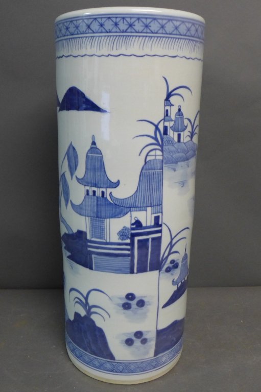 Chinese Blue and White Umbrella Stand: Beautiful porcelain umbrella stand decorated with outdoor landscape featuring bridge, river, boats mountains, houses and pagoda. No noticeable maker's marks. Slight chipping to bottom edge. No noticea