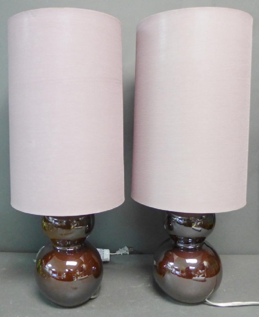 Pair Modern Ceramic Lamps: Double gourd form ceramic lamps with a glossy brown glaze. Accompanied by cylindrical light purple shades. No noticeable maker's marks. Height up to top of socket: 13 1/2" (lighting, electrical, table