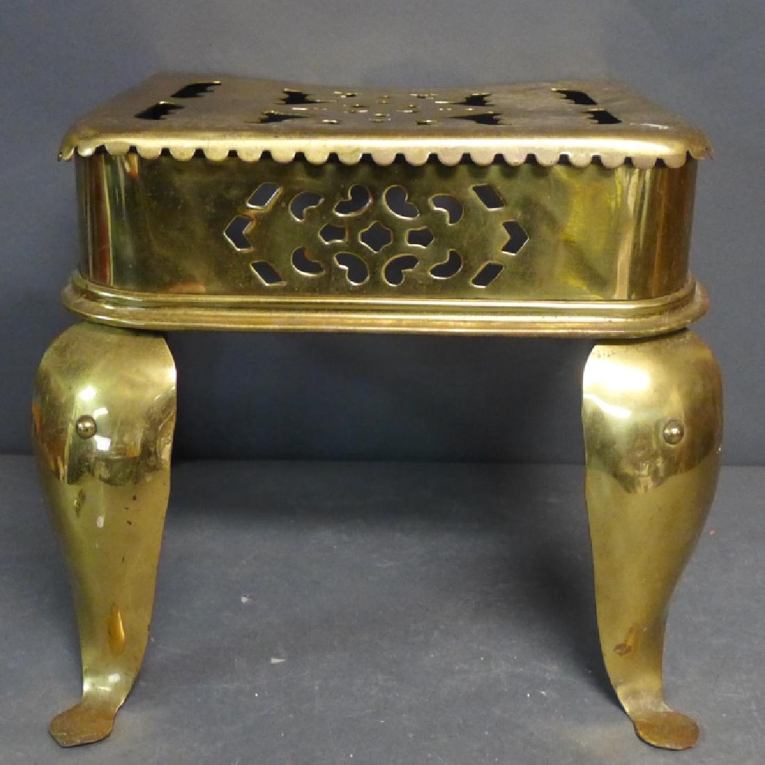 Vintage Brass and Iron Footman: Pierced brass and steel trivet/ footman. The front legs brass cabrioles terminating in 'penny' feet. Underframe is made of iron. Such trivets are sometimes used as a small side table. Trivets were use