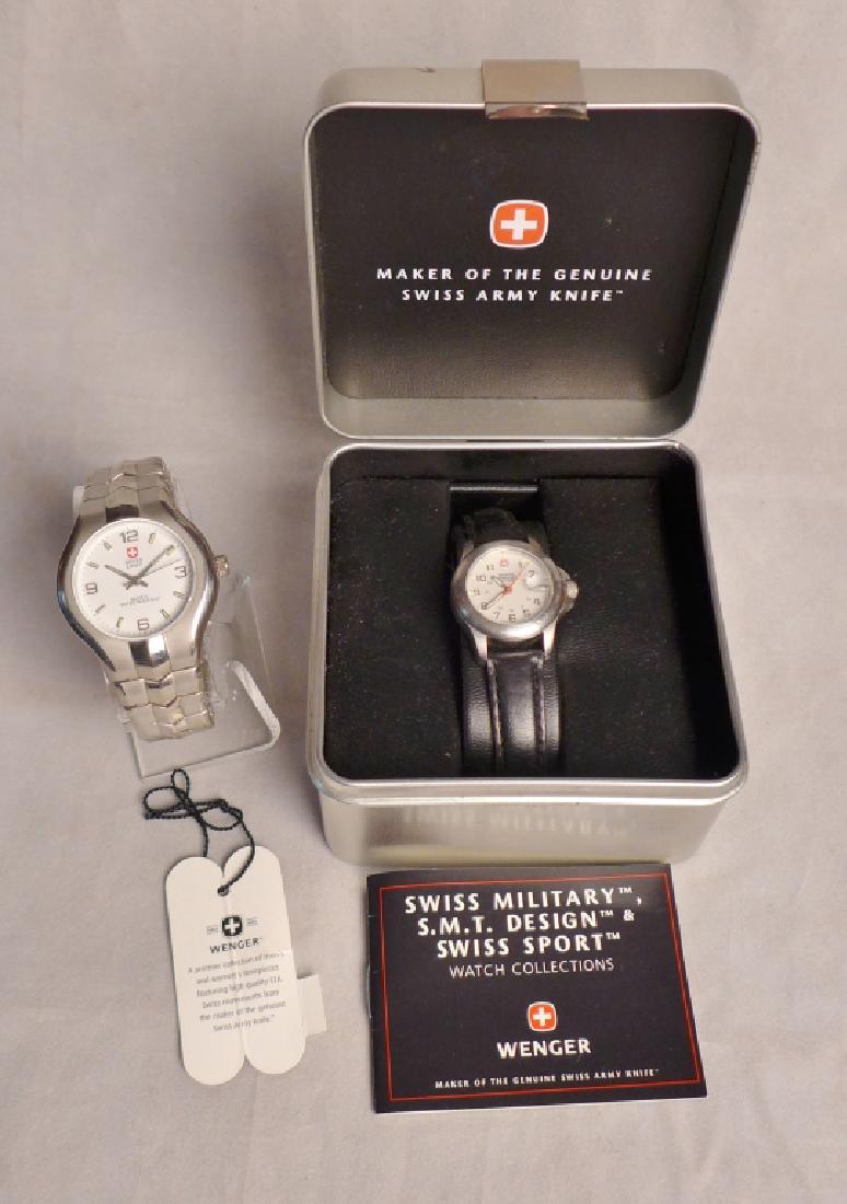 Pair of Swiss Army Watches: Pair of Swiss Army Watches. Includes: Wenger Swiss Military watch with leather band and case and Quartz Water resistant Swiss Army Watch with stainless band. Watch with leather band approximately 8 1/