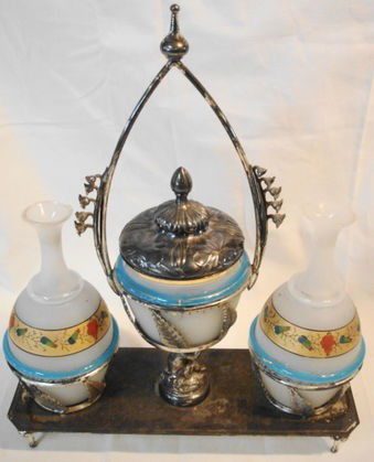 Victorian Hand painted Glass Dresser Set: Hand painted glass bottles & powder box in a silverplate carrier.Condition: Good, no chips, cracks or flakes to the glass, stoppers to jars missing. Numbered 123 on bottom.