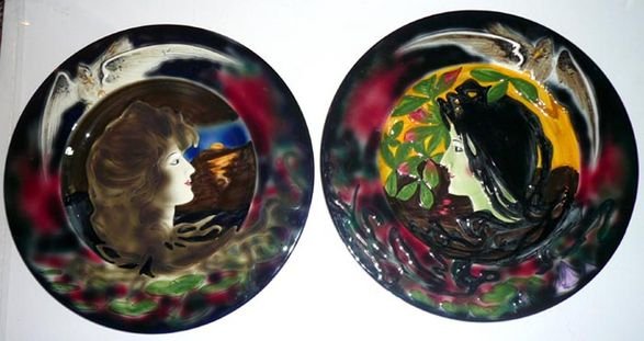 Art Nouveau German Majolica Chargers, pair.: Art Nouveau German Majolica Chargers, hand painted, darkly glazed background, shaded in green & mulberry. Centers feature profiles of women with flowing hair. White birds with outstretched wings perch