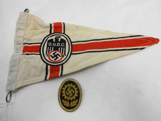 WW2 German DDAC Car Pennant & Pin: WW2 German DDAC Automobile Fender Pennant and Motor Pool Pin. Pin is Tin with fabric front . Marked on back RZ in circle and No. 391. Size: Pennant 10-1/2" x 6" Badge 2" x 1-1/2" Condition: Mild soili