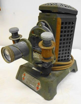 German Nazi Youth Projector, J H Bildgerat F 3157: German Nazi Youth Projector, J H Bildgerat, serial number F 3157, with Nazi Youth Emblems on plate.Condition: As found. Surface rust, original cord (frayed), top hinge is sprung.