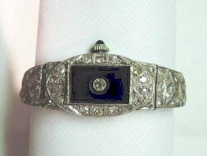 Art Deco Platinum, Diamond & Onyx Lady's Watch: Art Deco Platinum, Diamond & Onyx Lady's Watch. Sapphire jewelled stem. Face is marked Montrose. 49 cut diamonds total. Works are marked 15 jewels, 3 ADJ and Montrose, Swiss. Face is painted on the te