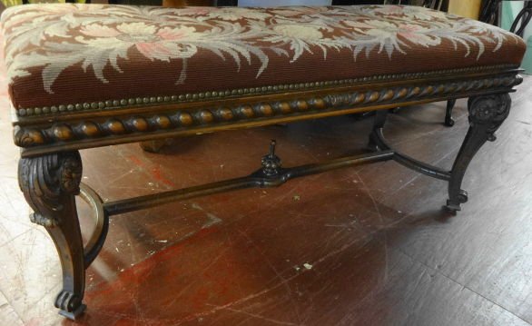 Carved bench with Needlepoint Seat: Carved Bench with needlepoint seat and nailhead trim.Dimensions: 48" (L) x 19" (W) x 21" (H)Condition: Very good. No chips or cracks noted to frame. Seat is immaculate.Provenance: Private estate