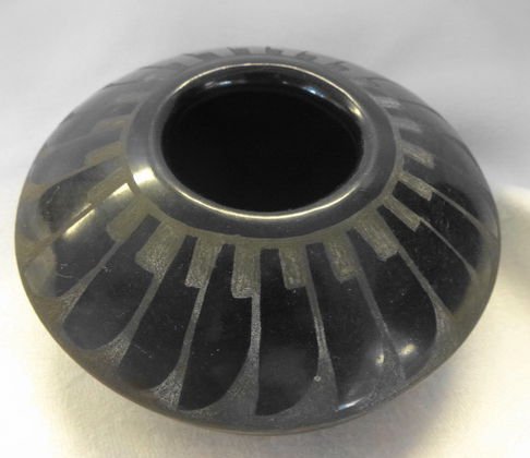 San Ildefonso Pueblo Black on Black Pottery, Signed: Description: San Ildefonso Pueblo black on black pottery, with geometric feather design,Signed: Illegibly on bottomDimension: 4"(D) x 1 3/4"(H)Condition: Very good. No chips, cracks or flakesProvenanc