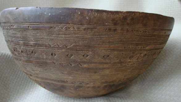 19th Century Large Carved Wood Bowl: Description: Decorated carved wood. Dimension: 7-1/2" H x 13-1/8" W Condition: Good (Please note old repair with staples) Provenance: Connecticut Estate.