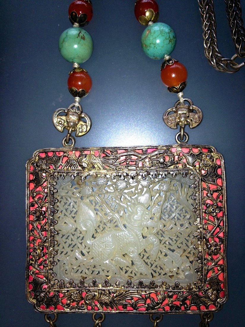 Chinese White Jade Turquoise & Carnelian Necklace: Description: Silver, jade, coral, turquoise, and carnelian. Dimension: Central rectangle which encases white jade 3" x 4". Length: 46" Condition: Very good Provenance: Private Connecticut Estate