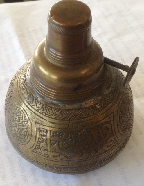 Antique Persian Miniature Oil Lamp with Calligraphy: Description: Islamic incised caligraphy and designs, very detailed.Dimension: 3-1/4" (H) x 3" (W) -at base.Origin: Syria, 19th centuryCondition: Very good working conditionProvenance: Originally acqui