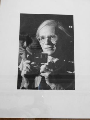 Andy Warhol With Camera, Ron Galella Photograph: Ron Galella (American b. 1931) Subject: Andy Warhol Description: Original silver gelatin photograph, signed and studio stamped on verso. Dimension: sheet: 11" x 14" ; image: 6 1/4" x 9" Condition: Ver