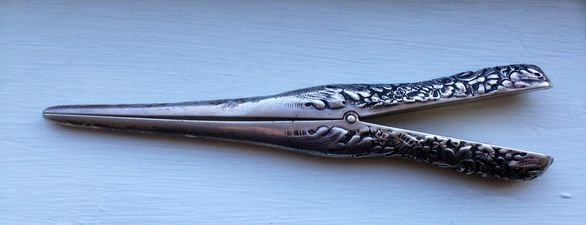Tiffany Sterling Silver Repousse Glove Stretcher C 1875: Tiffany sterling silver repousse glove stretcher, C 1875 Description: Elaborate repousse design on handles Marked: Sterling, Tiffany, NY and additional numbers. Dimensions: 7 1/2" Condition: Perfect w