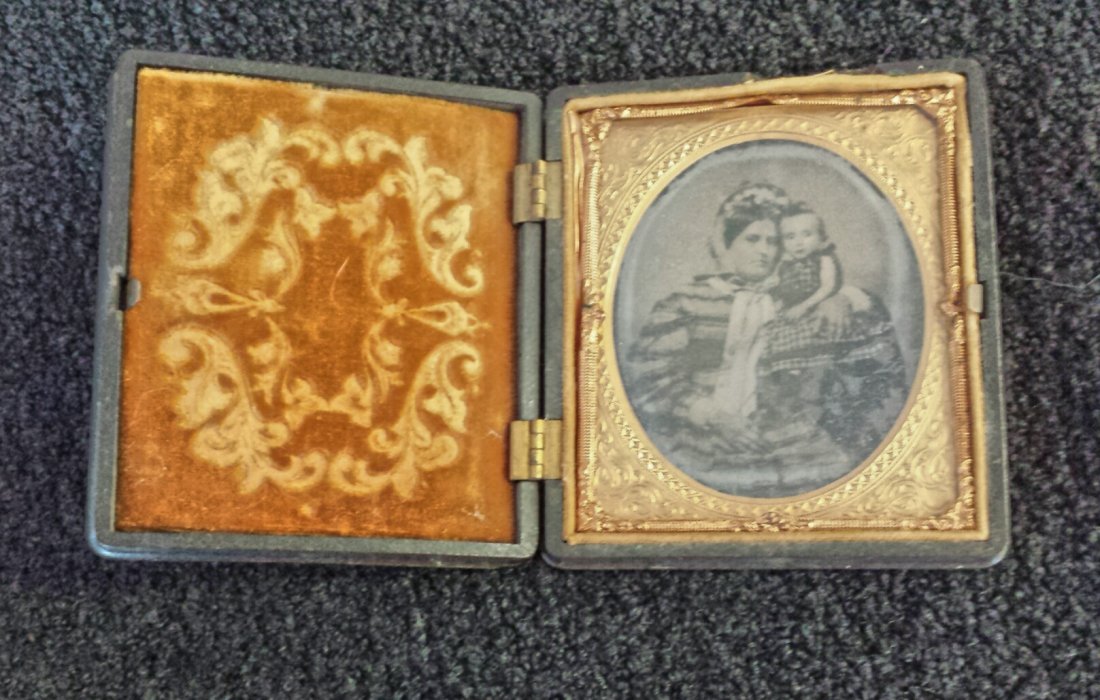 Civil War Era Ambrotype in Gutta Percha Case: Civil War Era Ambrotype in Gutta Percha Case. Subject: Mother & Baby Girl Size: 1/6 plate Dimensions: Plate: 2 3/4" x 3 1/4"; Case: 3 3/4" x 3 5/8" Condition: Very good original condition. Provenance: