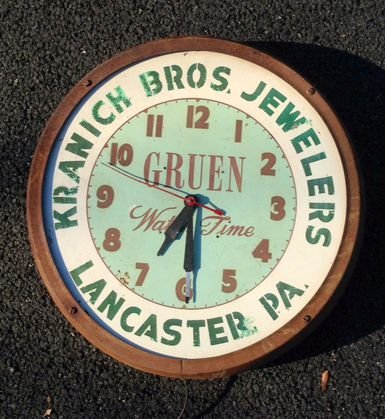 Gruen Watch Advertising Wall Clock: Enameled metal jewelers clock, Lancaster, PADimension:16" x 16"Not in working conditionProvenance: New Jersey Estate