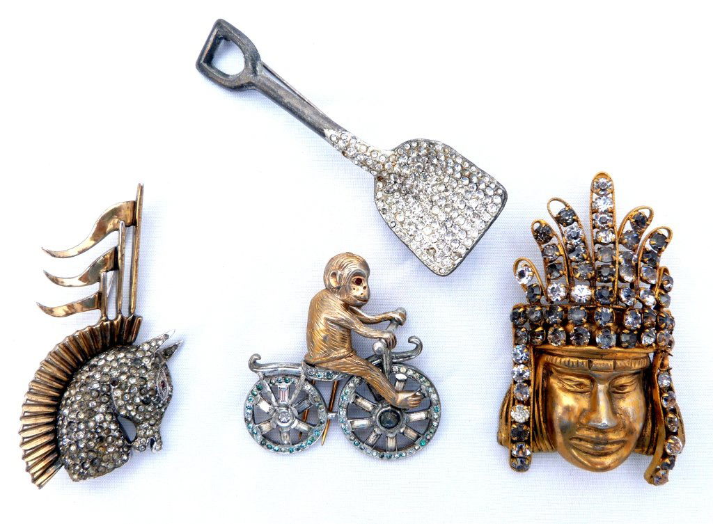 Assorted Costume Jewelry incl. Monkey on a Bike: Aztec Emperor Pin, pave Shovel, and a Horse. All encrusted with rhinestones.