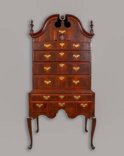 THE SAMUEL GARDNER IMPORTANT QUEEN ANNE WALNUT AND: Queen Anne bonnet-top high chest of drawers, in two sections, the upper with a broken arch top with enclosed bonnet centered by the original ball finial and a crotch-veneered tympanum containing a