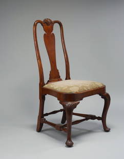 FINE QUEEN ANNE SHELL-CARVED BALLOON-SEAT WALNUT SIDE: The shell-carved crest rail above rounded stiles flanking a vasiform splat with deeply cut shoulders, the slip-in compass seat, supported by cabriole legs with shell-carved knees and ending in pad