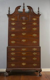 CHIPPENDALE MAHOGANY BONNET TOP CHEST-ON-CHEST: Of rare small size and constructed of richly-figured mahogany. In two sections: the upper with a closed bonnet with a vertically oriented bold concave cornice molding. The tympanum with carved