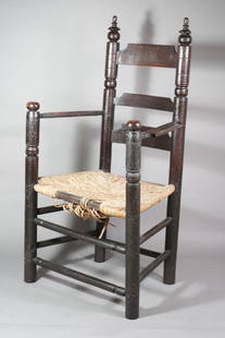 PAINTED TURNED MAPLE AND ASH GREAT CHAIR: New England, probably Eastern Massachusetts, circa 1690 Painted reddish-black, the back comprised of two turned posts capped by compressed ball and ring turned finials and flanking three slats, the