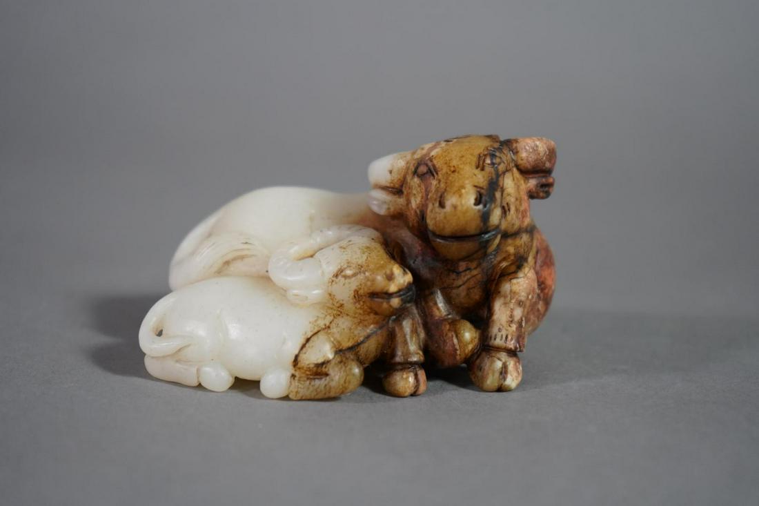 WHITE JADE WITH RUSSET CARVING OF OXEN WITH HER CALF: Ming Dynasty (1368-1644) Provenance: Property of a Distinguished European Gentleman Dimensions: Height: 2 1/4 in.Width: 3 7/8 in.Depth: 2 3/4 in.