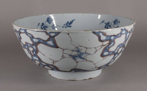 Tin Glazed English Delft 'Cracked Ice' Bowl: Probably London or Bristol, mid-18th Century The exterior painted in pale blue and manganese in the cracked ice pattern, the interior with blue floral sprays. D.10 1/2 in. Provenance: Bertie Guest