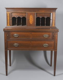 Federal Style Mahogany Tambour Desk: "Late 19th / early 20th century Rectangular top with molded edge, over a large tambour section fitted with six pigeonholes and two drawers and flanked by satinwood columns and centering a