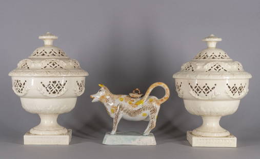 Pair of Creamware Covered Potpourri Pots: 18th century Each with double domed cover with toupie finial and pierced decoration accented with bellflower swags, similar decoration on the body, pedestal base with square foot and a Staffordshire