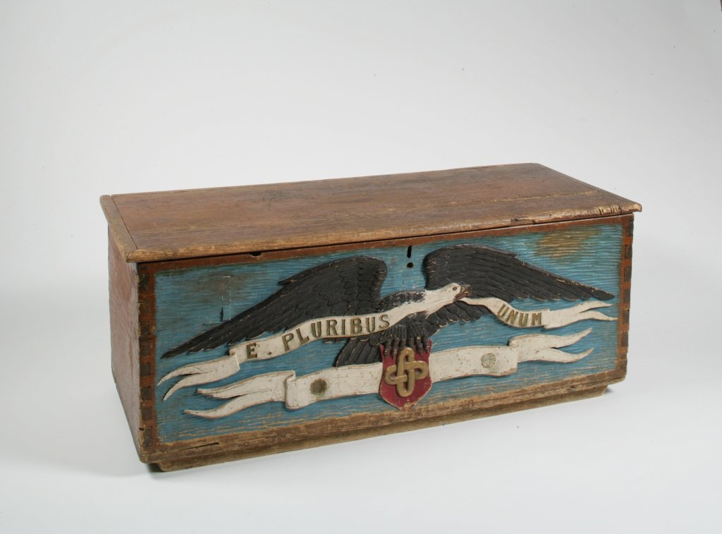 Carved and Painted Ship's Chest with Eagle: American 19th/20th Century Inscribed:"E PLURIBUS UNUM" H. 20 in.; W. 50 3/4 in.; D. 21 in. Estimate: $1,500 - $2,500