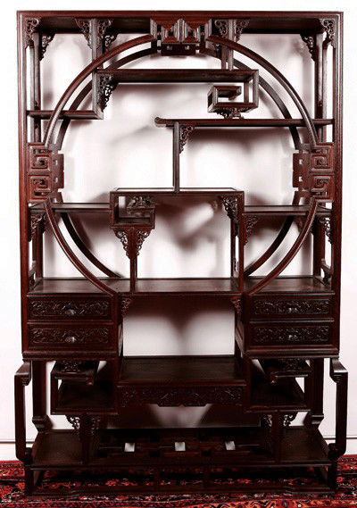 Qing Dynasty-Chinese JiChi (Chicken-Wing Wood) Dis: Dark ebony colored wood with irregular and alternating shelves of various sizes and shapes, open work details throughout, large circular motif highlights top section, two drawers on each side at botto
