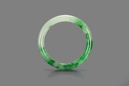 A Semi-Translucent Green Jadeite Bangle.