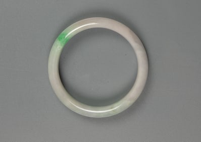 A Green And Light Lavender Jadeite Bangle.