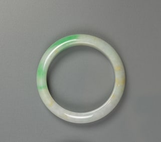 An Apple Green Jadeite Bangle.