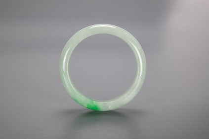 A Green Jadeite Bangle.