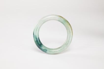 A Deep Green Jadeite Bangle.