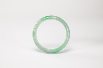 A Green Jadeite Bangle.