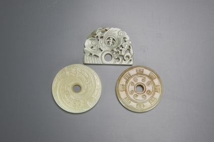 A Three Chinese Celadon White Jade Pendants
