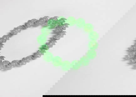 A Sixteen Apple Green Jadeite Beads Bracelet: A Sixteen Apple Green Jadeite Beads Bracelet Beads D: 12 mm 十六顆蘋果綠翡翠雕花珠手串 Provenance 來源 : Ō