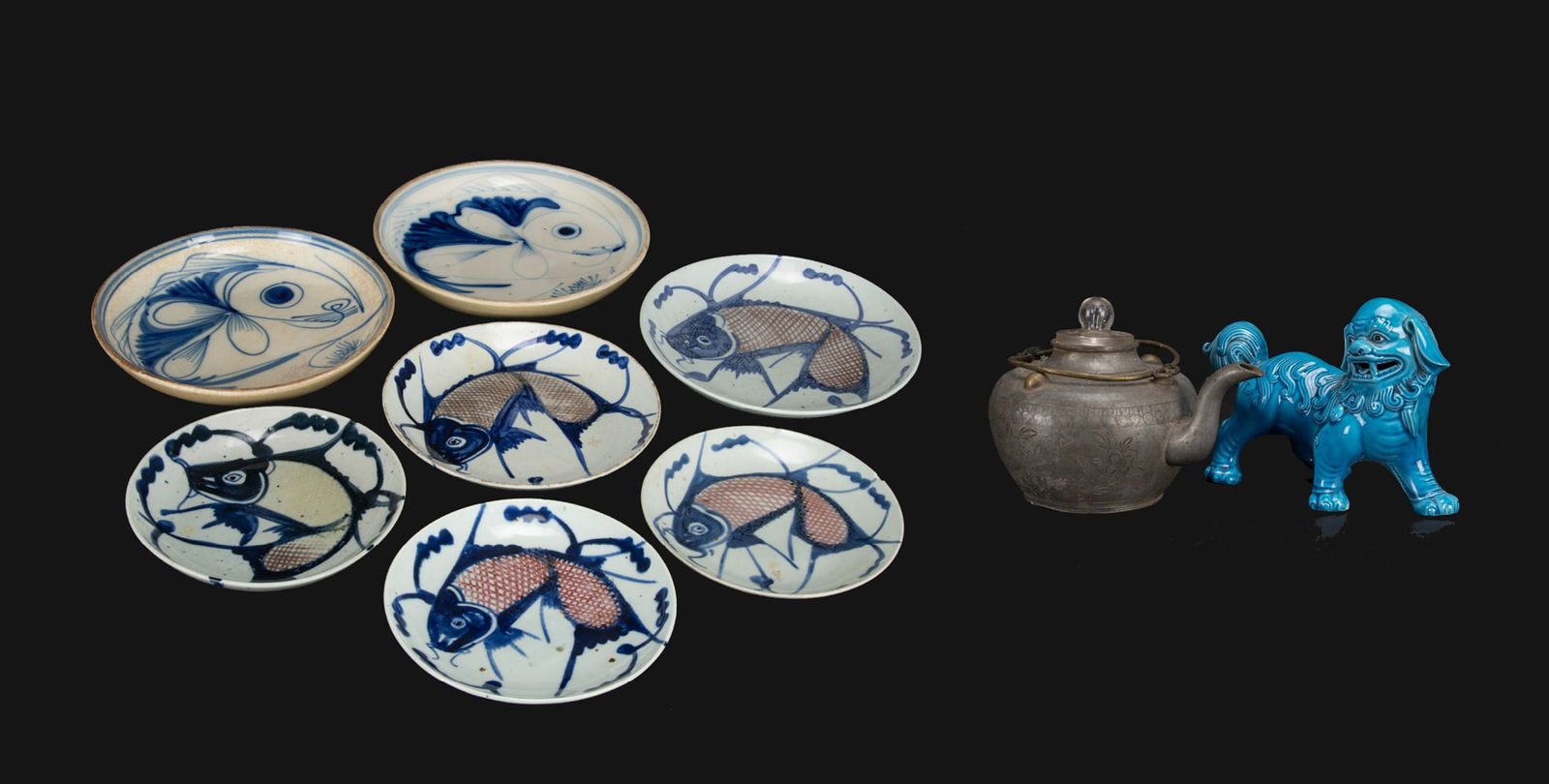 A Group of Nine Porcelain Dishes: A Group of Nine Porcelain Dishes with Carp, Blue Glazed Lion Figure, and a Pewter Teapot. Qing Dynasty D: 26.5 cm - 20.1 cm( 尺寸不一） 清 - 七青花