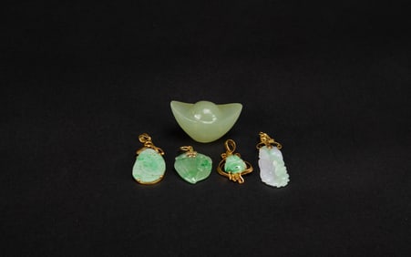 A Group Of Four Jadeite Pendants