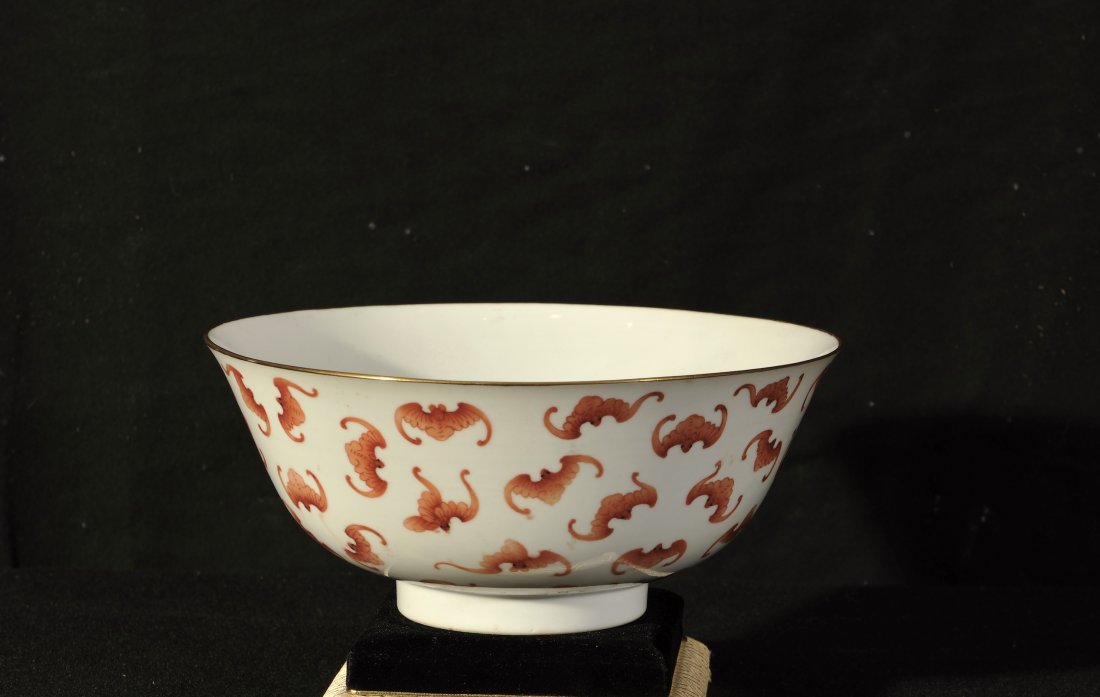 Tong Zhi.An iron-red glaze ‘Hundred bats’ bowl “Tong: Tong Zhi. An iron-red glaze ‘Hundred bats’ bowl “Tong Zhi Nian Zhi” mark and of period. D: 20.7 cm. (8 1/8 in.) 清同 同治礬紅百福碗“