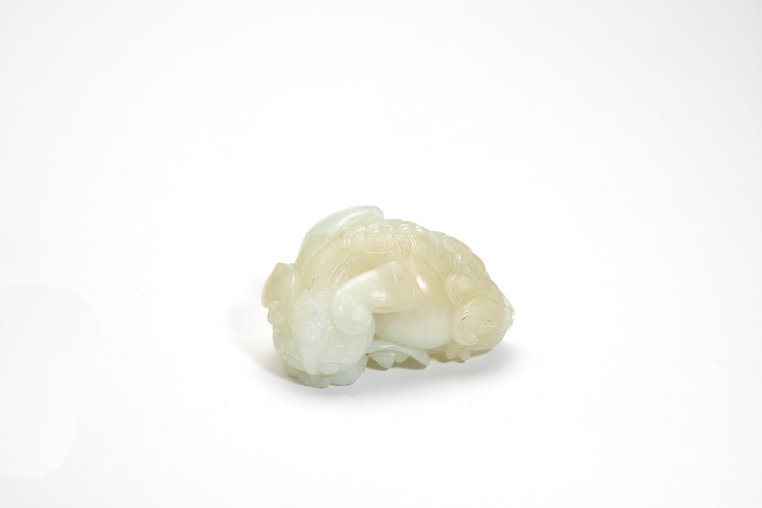 A White Jade Carving of a Recumbent Lion, Late Qing