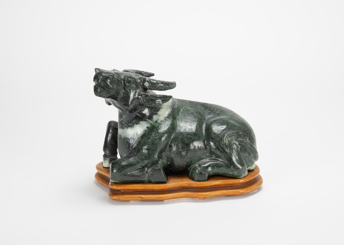 A Spinish Jade Cow With Stand: A Spinish Jade Cow With Stand20 X 12 X 15.5 cm (With Stand)玉雕臥牛擺件（木座） Provenance 來源：舊金山&
